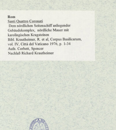 Rückseite von unbekannt [https://www.deutsche-digitale-bibliothek.de/content/lizenzen/rv-ez/] Santi Quattro Coronati - Dem nördlichen Seitenschiff anliegender Gebäudekomplex, nördliche Mauer mit karolingischen Kragsteinen, bh469612_recto. Foto: Corbett, Spencer.
